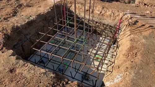Isolated footing ready to pour concrete in a construction site. Foundation iron cage with rebars for