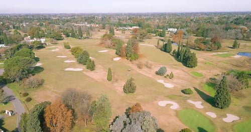 AERIAL - Sand traps and the green at a golf club, forward wide shot