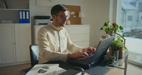Male Entrepreneur Working on Laptop at Office