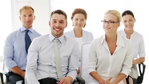 Smiling Business Team Giving Thumbs Up in Office