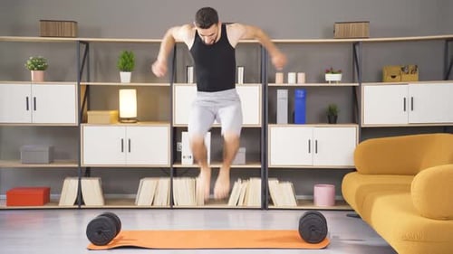 Young Man Doing Jumping Jacks at Home