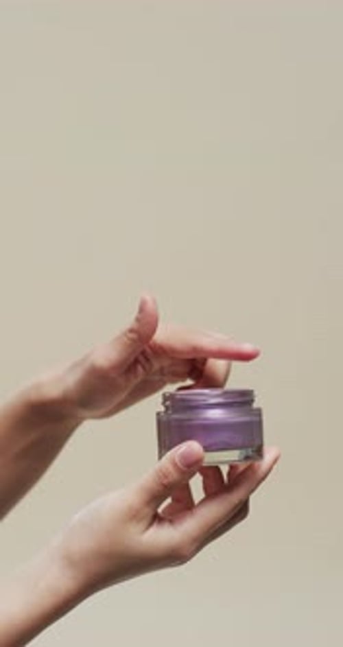 Hands Opening a Jar of Cosmetic Cream