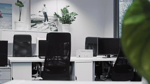 Shot of empty desks in an office in the afternoon.