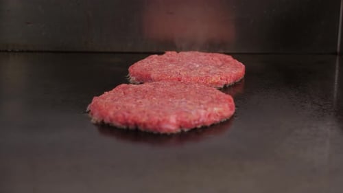 Closeup of Two Meat Burgers Fried in the Kitchen of the Restaurant