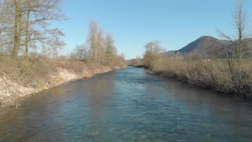 Dron flying above the slow river water with peaceful background