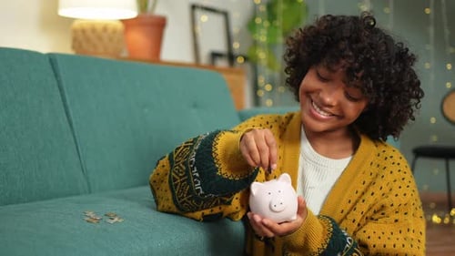 Saving Money Investment for Future African American Girl Holding Pink Piggy Bank and Putting Money