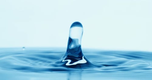 Drop of water falls into a drop of water in a super slow motion. Shot on super slow motion 1600 fps.