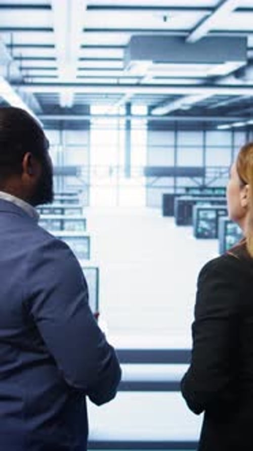 Vertical Video Data Center Engineer Presenting Equipment to Inspector Supervising Operations