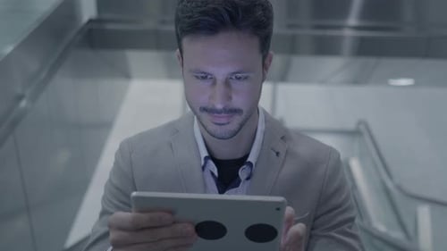 Businessman Networking on Mobile Tablet Device in the City
