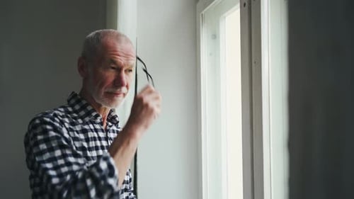 An Old Man in a Hospice at the Window