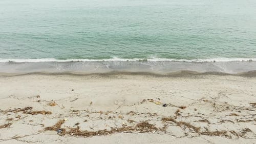 Beach Polluted With Plastic Debris And Other Scrap From The Ocean