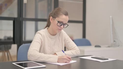 Young Woman Writing a Letter in Office