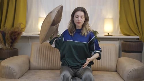 Sad Young Woman on Sofa in Home Setting