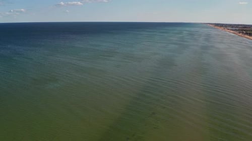 Beautiful flight in summer over the beach. People are resting near the sea. Houses for tourists.