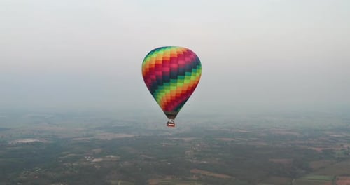 Aerial shot of colorful hot air balloon is flying on a scenic panoramic view in the sky on a sunny