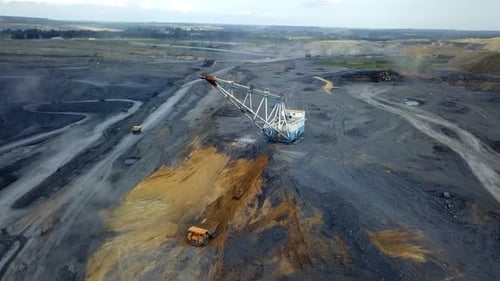 An Aerial View Capturing a Mining Site Complete with Heavy Machinery Operating Below Stock Clip