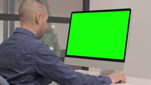 Hispanic Businessman Working on Computer with Green Screen