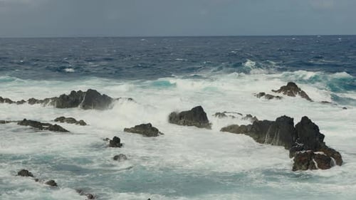 Aerial View of Waves Splashing in Sea and Rock in Water