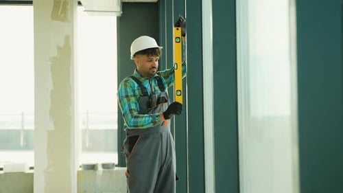 Construction Worker Using Spirit Level on Window Frame