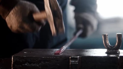 Blacksmith Working on Red Hot Metal at Anvil