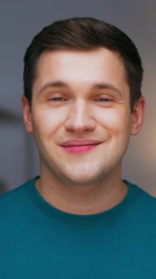Portrait of Happy Man Looking at Camera with Smiling Face on Home Background