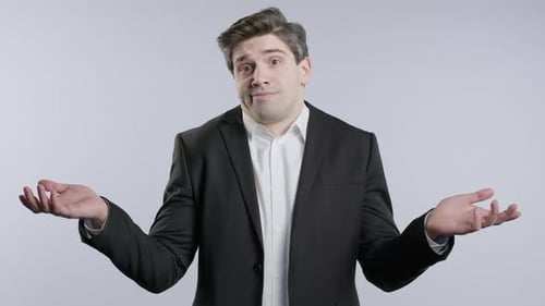 Man in Suit with Puzzled Hand Gesture