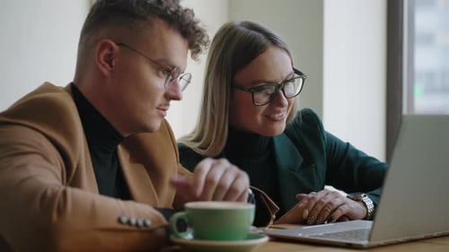 Joyful Colleagues are Working Together on New Project in Office Communicating and Laughing