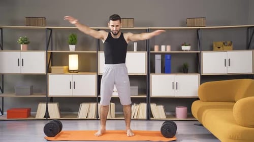 Man Exercising and Playing Sports at Home.