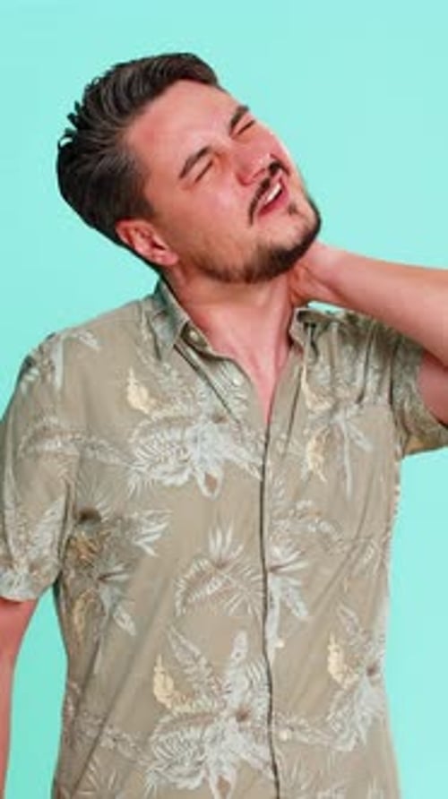 Man in Floral Shirt Massaging Stiff Neck Muscles