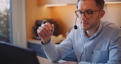 Man Wearing Headset Working at Computer