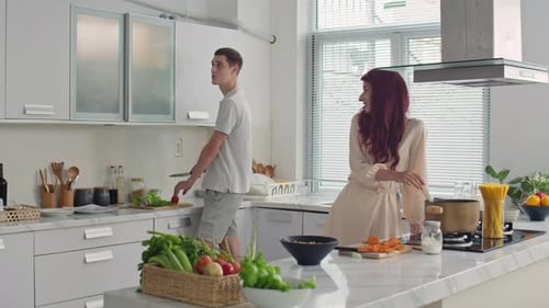 Young Couple Cooking Food Together in Kitchen