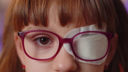 Child Wearing Glasses and Eye Patch, Close Up