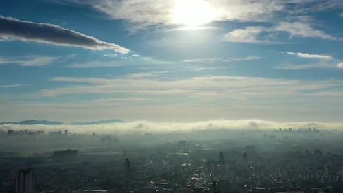 Above the clouds. Sunrise foggy morning at downtown city.