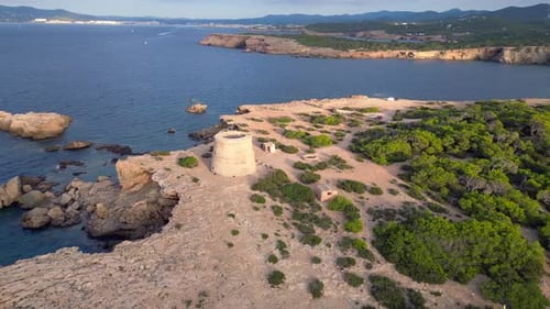 mediterranean coastal sunset ancient historic tower. Fantastic aerial top view flight panorama orbit