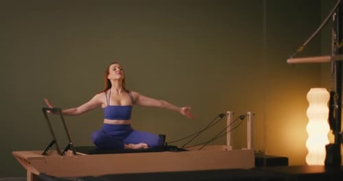 Woman Demonstrates Pilates Arm and Torso Stretches