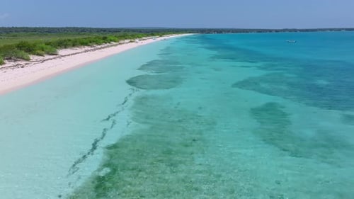 Aerial forward panorama exotic white sand beach paradise in the Caribbean