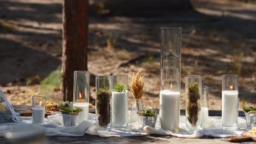 Wedding Party Banquet Outdoors in Forest Dining Table Decorated in Boho Style with Candles White