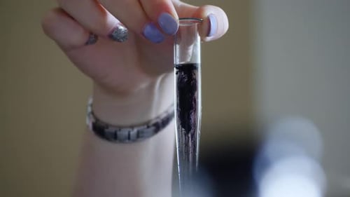 Close Up of Hand Holding Test Tube