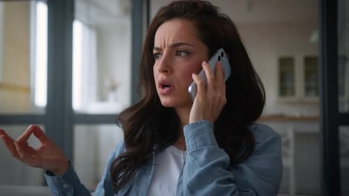 Woman Having Serious Phone Call at Home