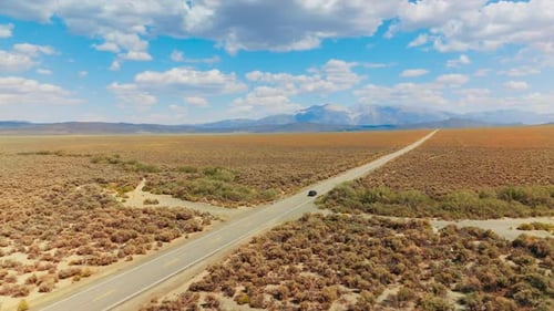 Highway riding desert road. Car driving along the road in the valley.