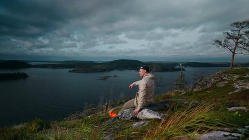 Trip To Mountains Inspired Man Sitting Alone At Top Of Rock And Viewing Beautiful Natural Landscape