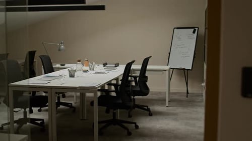 Interior of Boardroom with Central Desk and Whiteboard in Office Space