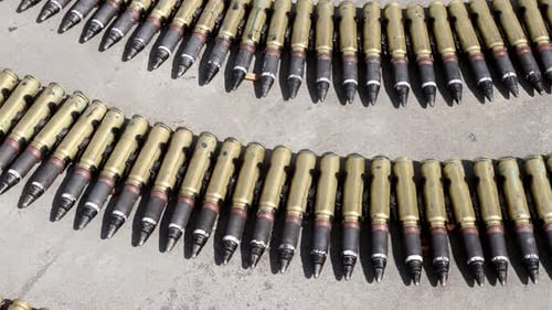 Linked Ammunition Rows Lying on Concrete