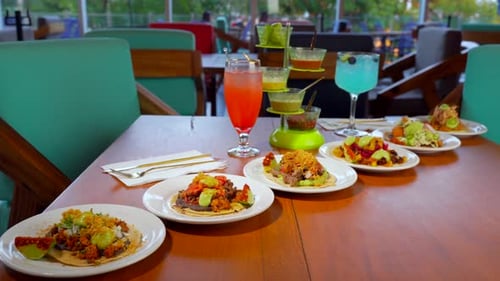 Mexican restaurant table full of tacos fish seafood beef pork slider shot cocktails