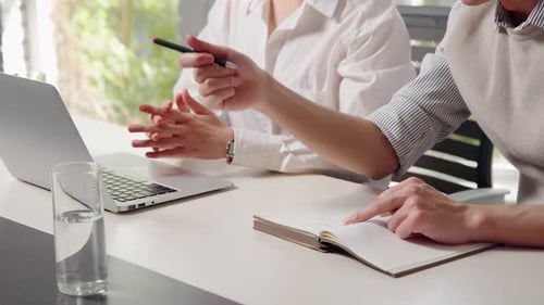 Coworkers Collaborating on Project at Modern Office