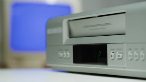 Inserting VHS tape into a retro VCR
