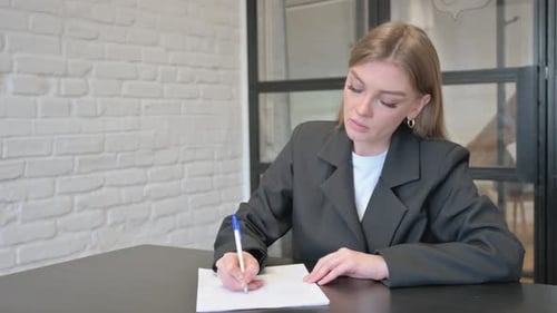 Businesswoman Writing a Letter in Office