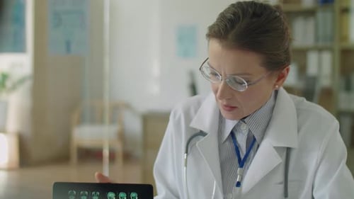 Female Doctor Explaining CT Scan on Medical Consultation