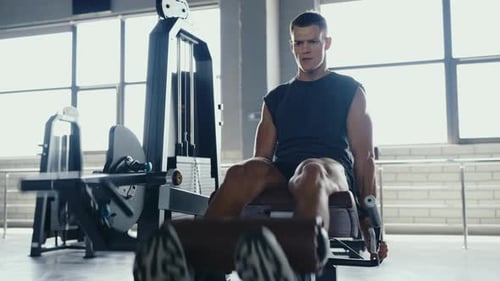 Man Exercising at Gym Using Leg Press Machine for Strength Training