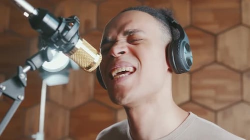 Young African American Man Singer Performs New Song in Recording Studio